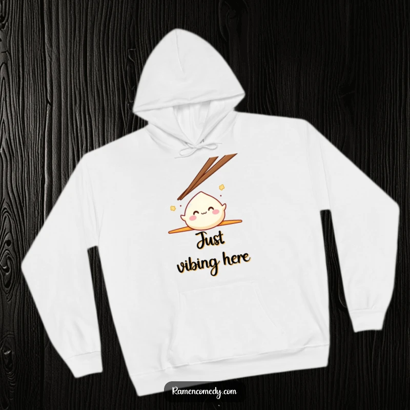 Funny Mochi Hoodie with a smiling mochi character happily bouncing between two oversized chopsticks, perfect for cozy, cheerful wear.