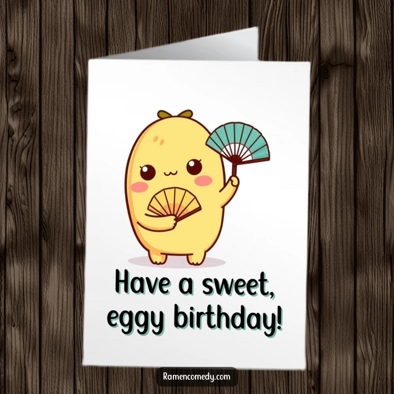 Funny Free Printable Birthday Card: A charming tamagoyaki character holding a tiny fan, wishing a cool and breezy birthday celebration.